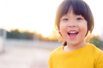 image of a happy little girl - Jungle Roots Pediatric Dentistry